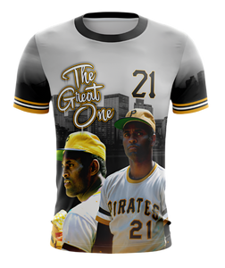 A t-shirt featuring a graphic design with the text 'The Great One 21', depicting a baseball player in a Pirates uniform, in reference to Roberto Clemente.