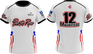 A white round neck t-shirt with short sleeves featuring red and blue accents and text that reads '12 Magníficos'. There is also text 'Puerto Rico' and 'Taino Shirts' on the shirt.