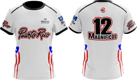 A white round neck t-shirt with short sleeves featuring red and blue accents and text that reads '12 Magníficos'. There is also text 'Puerto Rico' and 'Taino Shirts' on the shirt.