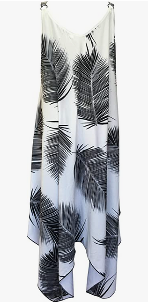 A chic white dress with bold black palm leaf patterns, featuring a sleeveless, asymmetrical hem design, ideal for a stylish tropical beach look.