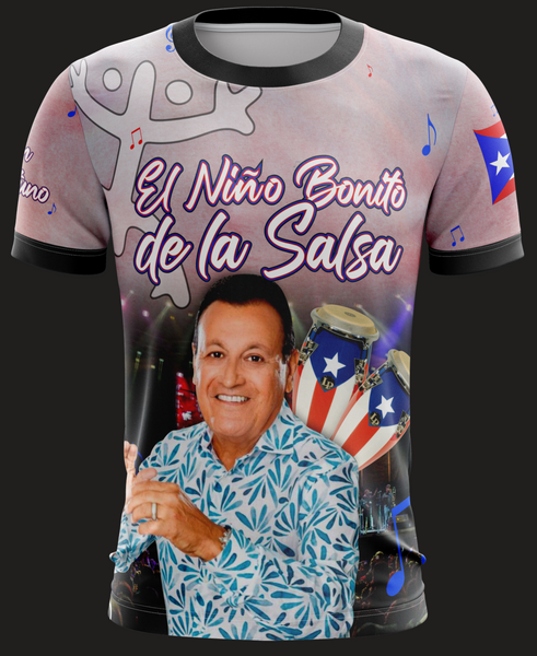 A t-shirt with a graphic print featuring a man and the text 'El Niño Bonito de la Salsa', with various colors predominantly used for the design.