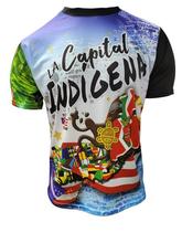 A vibrant t-shirt celebrating Jayuya, Puerto Rico as "La Capital Indigena" with front and back designs. The front features bold text "La Capital Indigena Jayuya" alongside indigenous Taino symbols, a coqui frog, sun emblem, and Puerto Rican flag elements on a blue gradient background. The back showcases a scenic mountain landscape with a "Jayuya Isla del Encanto" sign, Taino petroglyphs, and a Gufeao logo, perfect for expressing Jayuya pride and Puerto Rican indigenous heritage.