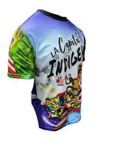 A vibrant t-shirt celebrating Jayuya, Puerto Rico as "La Capital Indigena" with front and back designs. The front features bold text "La Capital Indigena Jayuya" alongside indigenous Taino symbols, a coqui frog, sun emblem, and Puerto Rican flag elements on a blue gradient background. The back showcases a scenic mountain landscape with a "Jayuya Isla del Encanto" sign, Taino petroglyphs, and a Gufeao logo, perfect for expressing Jayuya pride and Puerto Rican indigenous heritage.