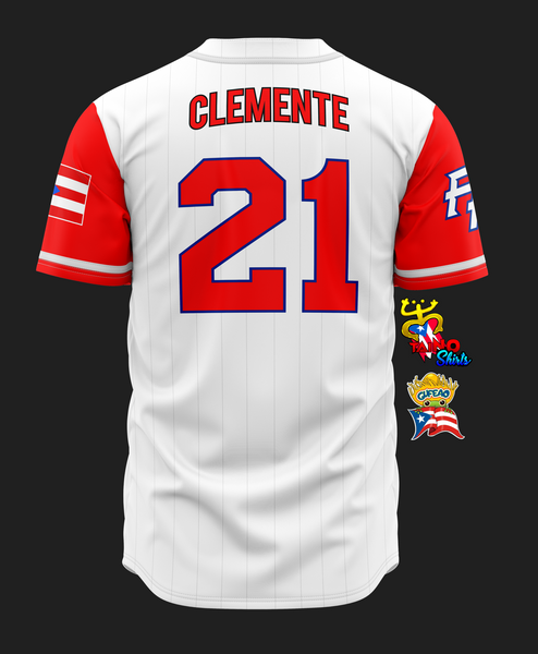 A white baseball jersey with red and blue accents featuring "Puerto Rico" in bold text, the Puerto Rican flag on the sleeve, a "21" patch honoring Roberto Clemente, and Taino-inspired designs including a coqui frog and crown, set against a black background.