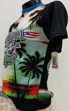 Left and right views of a vibrant Puerto Rican shirt featuring "Boricua Como El Coquí" text, palm trees with a sunset background, and the Gufeao mascot with the Puerto Rican flag, celebrating cultural identity and natural beauty.