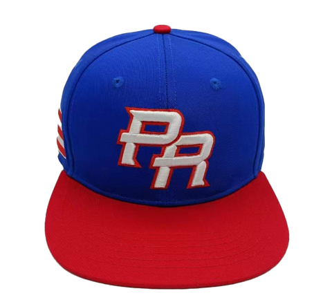 A fitted baseball hat with a blue crown and red brim, featuring embroidered 'PR' logo in white and red.