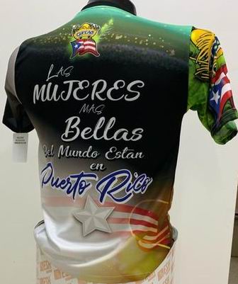 Left and right views of a vibrant Puerto Rican shirt with "Sin Duda" and "Las Mujeres Bellas del Mundo Están en Puerto Rico" text, featuring a map, stars, and the Gufeao mascot with the Puerto Rican flag, celebrating cultural beauty and pride.