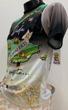 Left and right views of a vibrant Puerto Rican shirt with "Sin Duda" and "Las Mujeres Bellas del Mundo Están en Puerto Rico" text, featuring a map, stars, and the Gufeao mascot with the Puerto Rican flag, celebrating cultural beauty and pride.