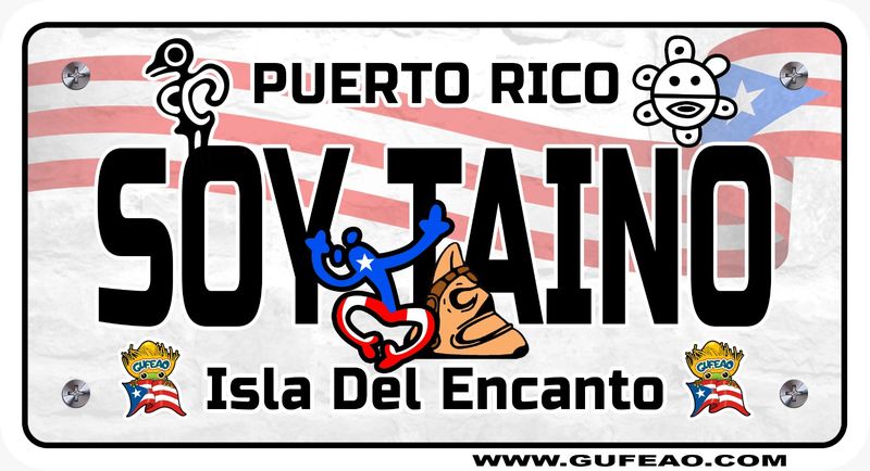 A stylized license plate with a background of the Puerto Rican flag's red and white stripes and blue triangle with a white star. The word "SOY TAINO" is prominently displayed in large black letters, with "PUERTO RICO" above in black. A blue Taino figure and a Taíno sun symbol are integrated into the design. Below, "Isla Del Encanto" is written in black, flanked by two "Gufeo" cartoon characters with flags. The website "www.gufeo.com" is at the bottom.