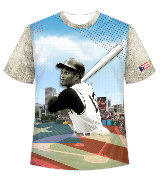 A stylish t-shirt featuring front and back designs honoring Roberto Clemente, a legendary baseball player. The front showcases Clemente in his batting pose against a stadium backdrop with a Puerto Rican flag, while the back displays his number 21 and name in bold, set against a distressed flag design.