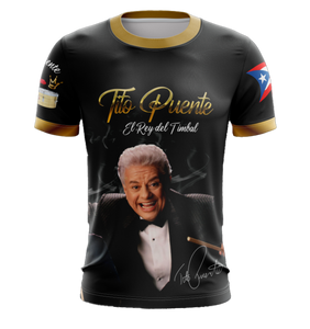 A black T-shirt featuring an image of Tito Puente with text 'Tito Puente El Rey del Timbal' and the flag of Puerto Rico.