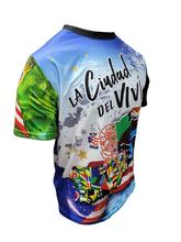 A vibrant t-shirt celebrating Utuado, Puerto Rico as "La Ciudad del Viví" with front and back designs. The front features bold text "La Ciudad del Viví" with a colorful flag collage, a sun emblem, and a blue gradient background with the Puerto Rican flag. The back showcases a rural scene with a horse, a "Utuado Isla del Encanto" sign, and a large star with a Gufeao logo, perfect for expressing Utuado pride and Puerto Rican heritage.