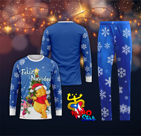 A pajama set with blue pants and a blue top featuring white snowflakes and a Winnie the Pooh character with a Christmas theme.