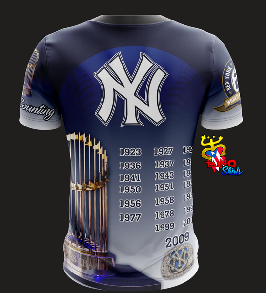 A stylish Bronx Bombers t-shirt featuring the New York Yankees logo, 'Yankees' text, and a vibrant Yankee Stadium design. The shirt includes championship patches and is branded by Taino Shirts, ideal for baseball fans and collectors